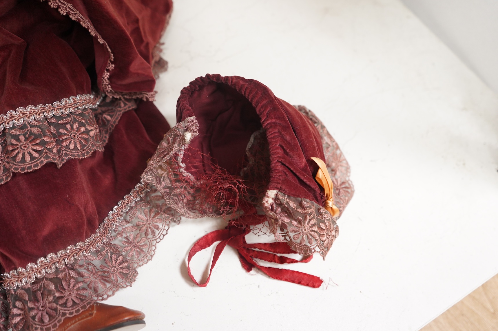 Two bisque dolls in matching Victorian clothing, 60cm high